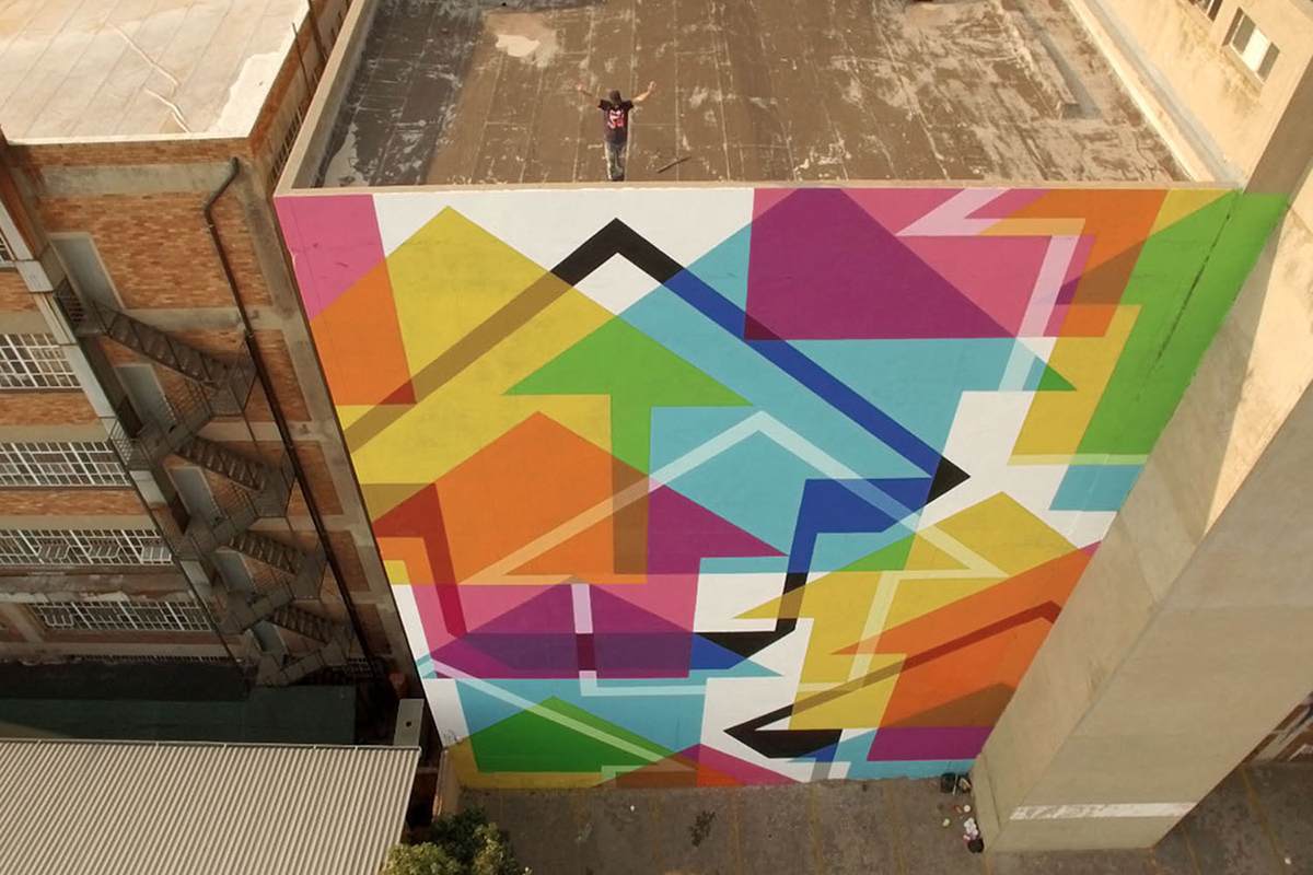ABOVE street art mural using his iconic UP arrows